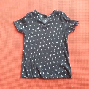 A black top with white/yellow flowers on